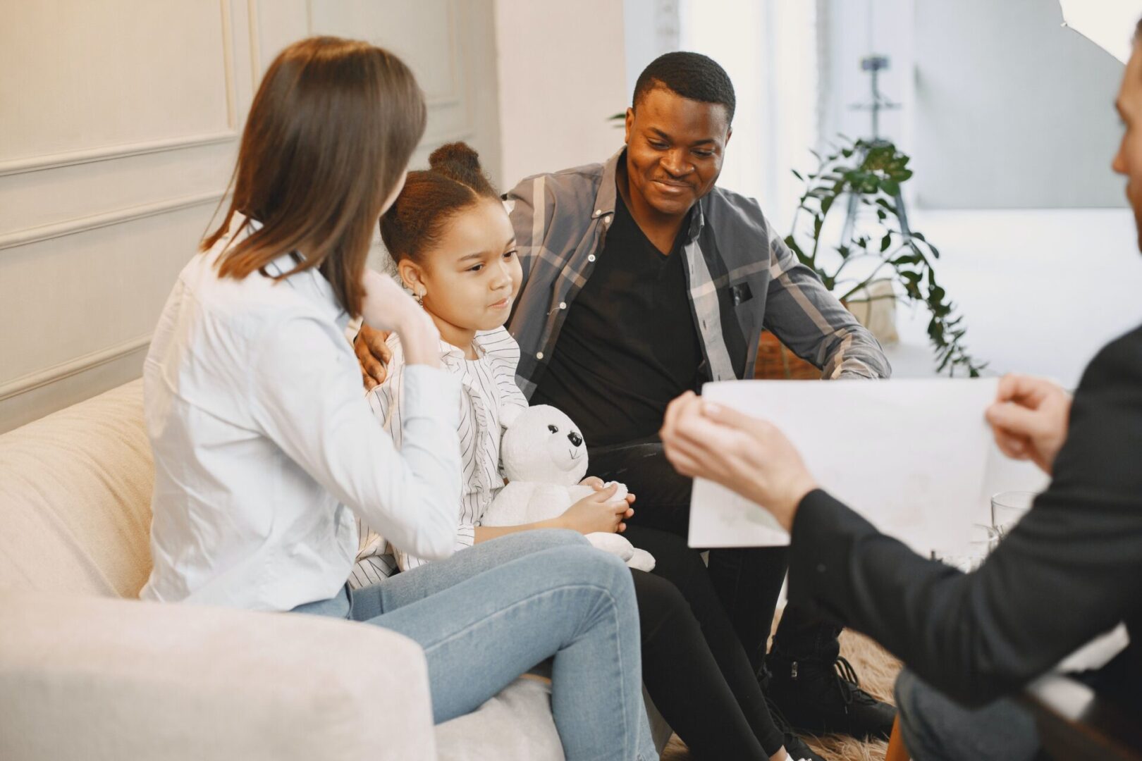 A group of people sitting on top of a couch.